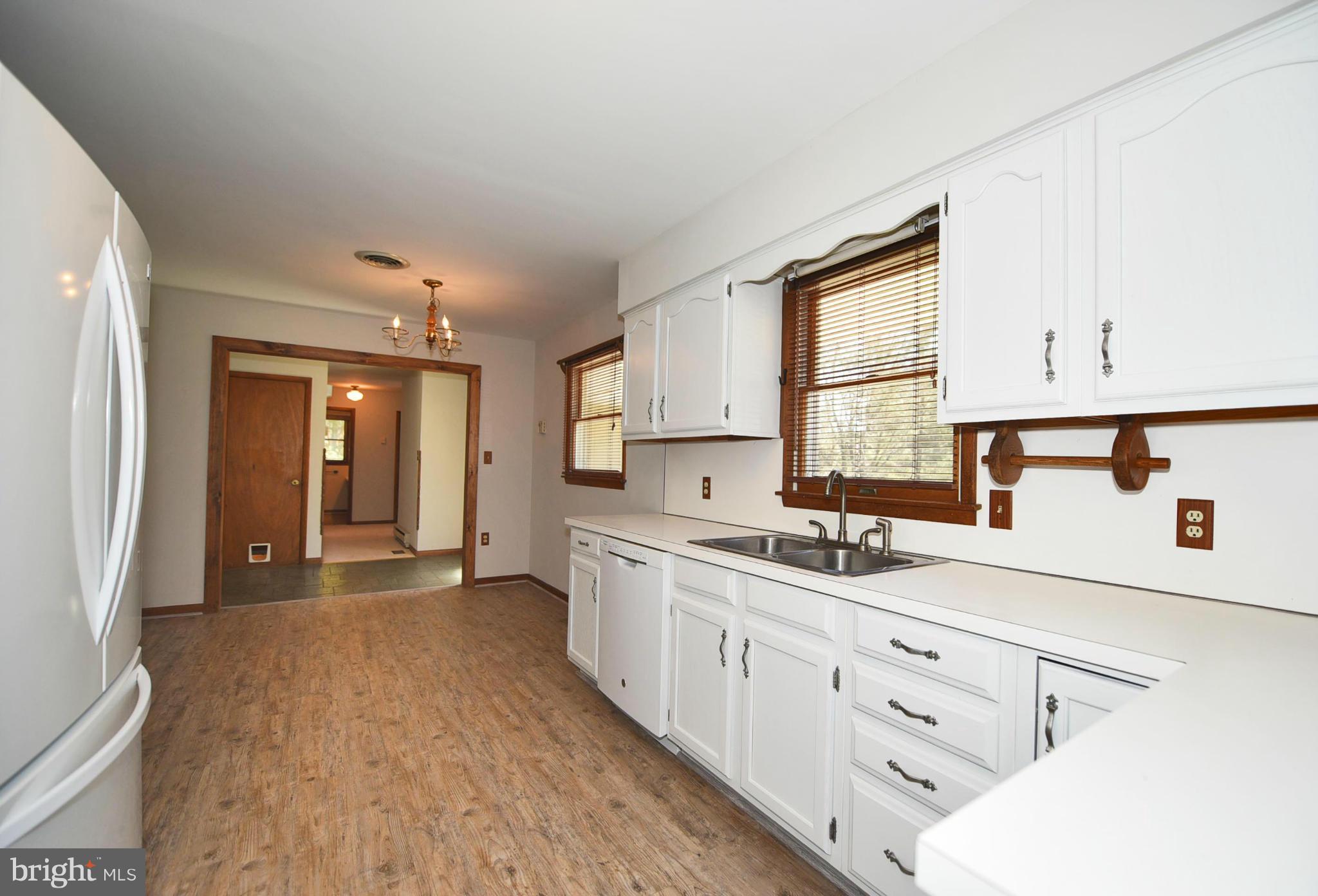 911 Ridge Road Rising Sun, MD 21911 - Photo 20 of 30 a kitchen with granite countertop white cabinets and white appliances