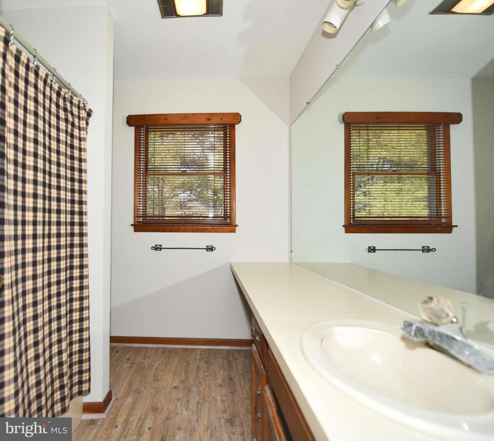 911 Ridge Road Rising Sun, MD 21911 - Photo 25 of 30 a bathroom with a granite countertop sink and a large mirror