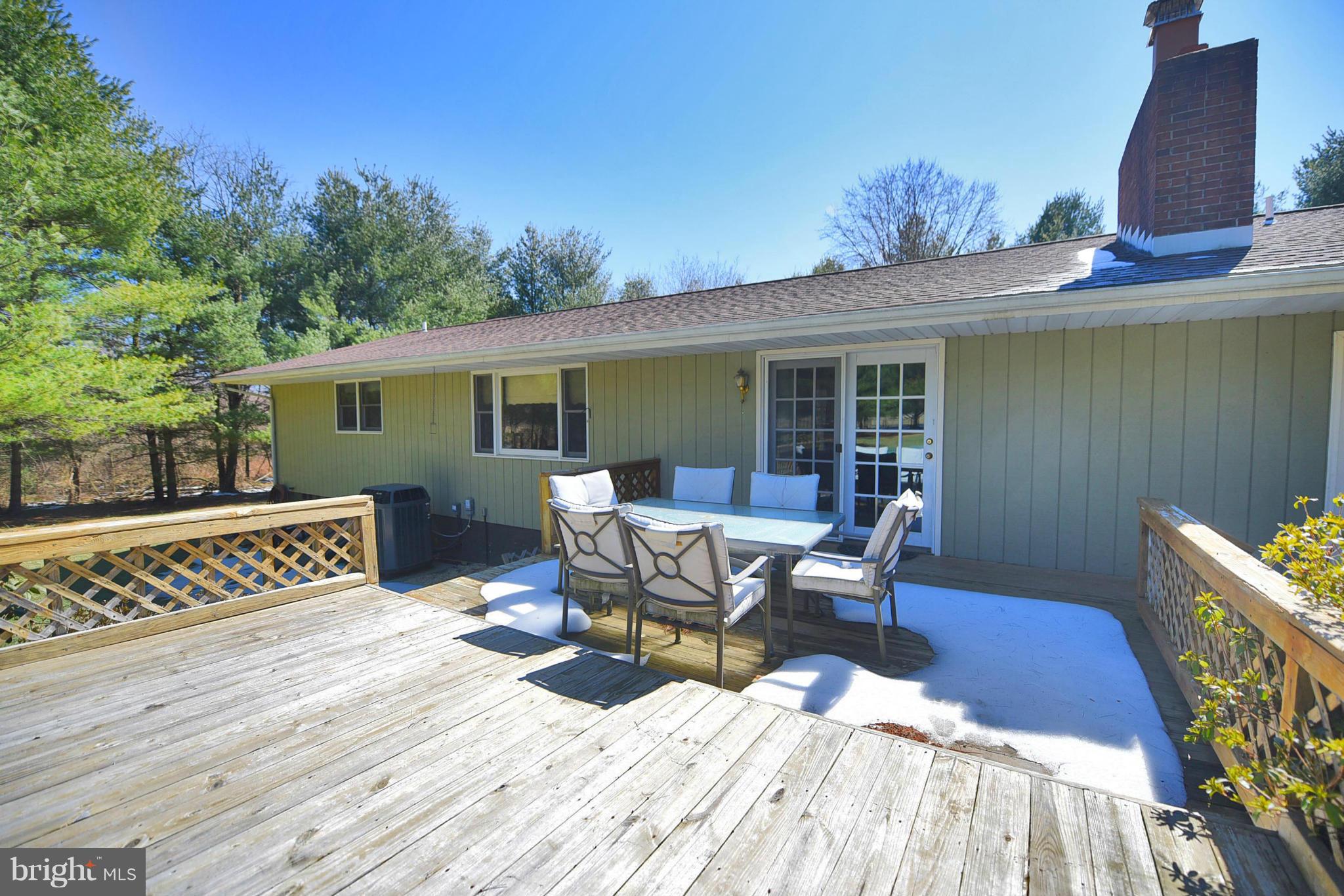 911 Ridge Road Rising Sun, MD 21911 - Photo 4 of 30 a view of a patio with table and chairs with wooden floor and fence
