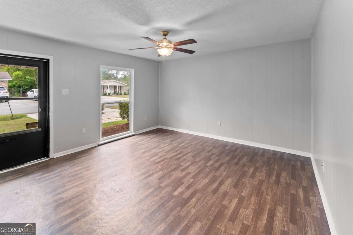 320 West Whatley Street Pooler, GA 31322 - Photo 7 of 34 wooden floor in an empty room with a window