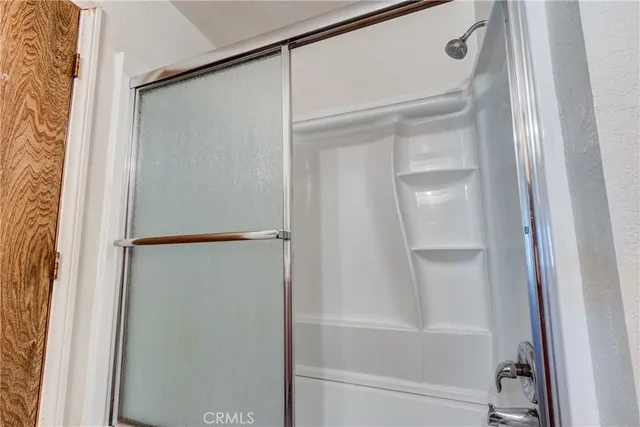 a bathroom with a glass shower door
