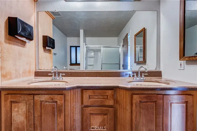 a bathroom with a double vanity sink and a mirror