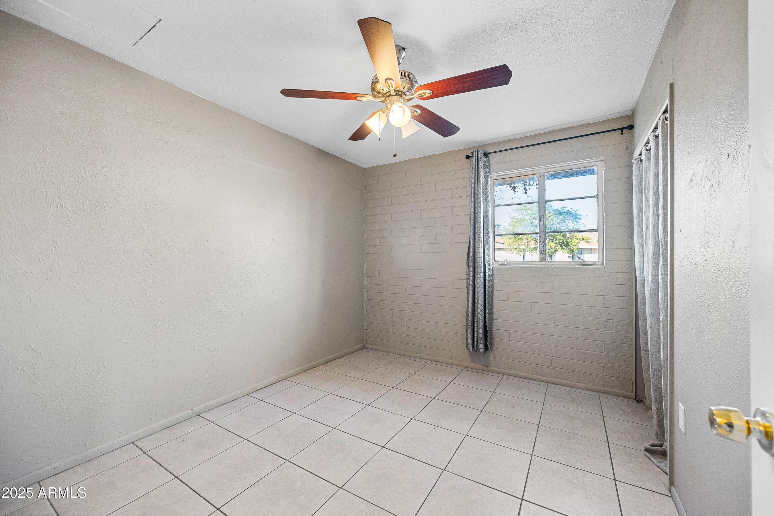 2057 East 10th Street Tempe, AZ 85281 - Photo 12 of 26 wooden floor in an empty room with a window