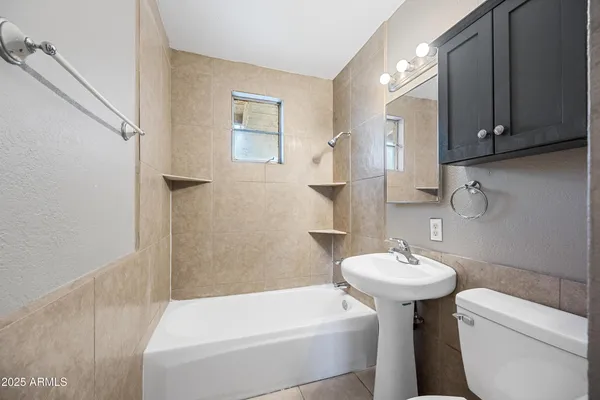 a bathroom with a sink a toilet and bathtub