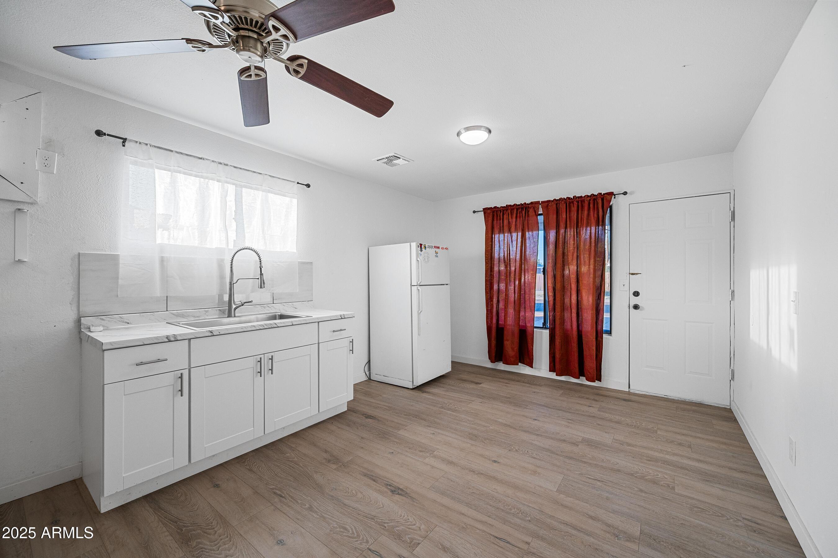 2057 East 10th Street Tempe, AZ 85281 - Photo 18 of 26 a very nice looking room with a chandelier fan and a wooden floor
