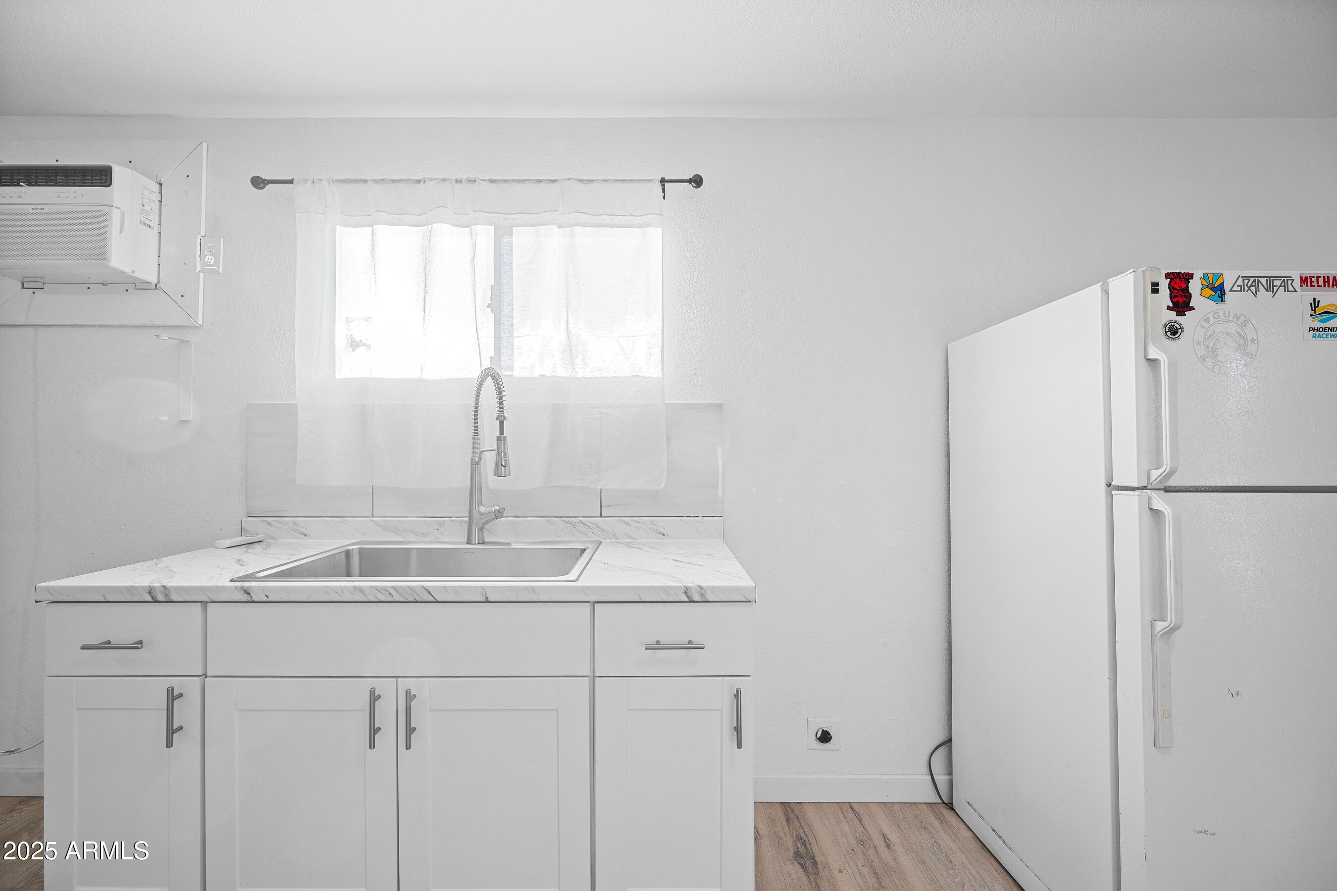 2057 East 10th Street Tempe, AZ 85281 - Photo 19 of 26 a kitchen with a sink refrigerator and window