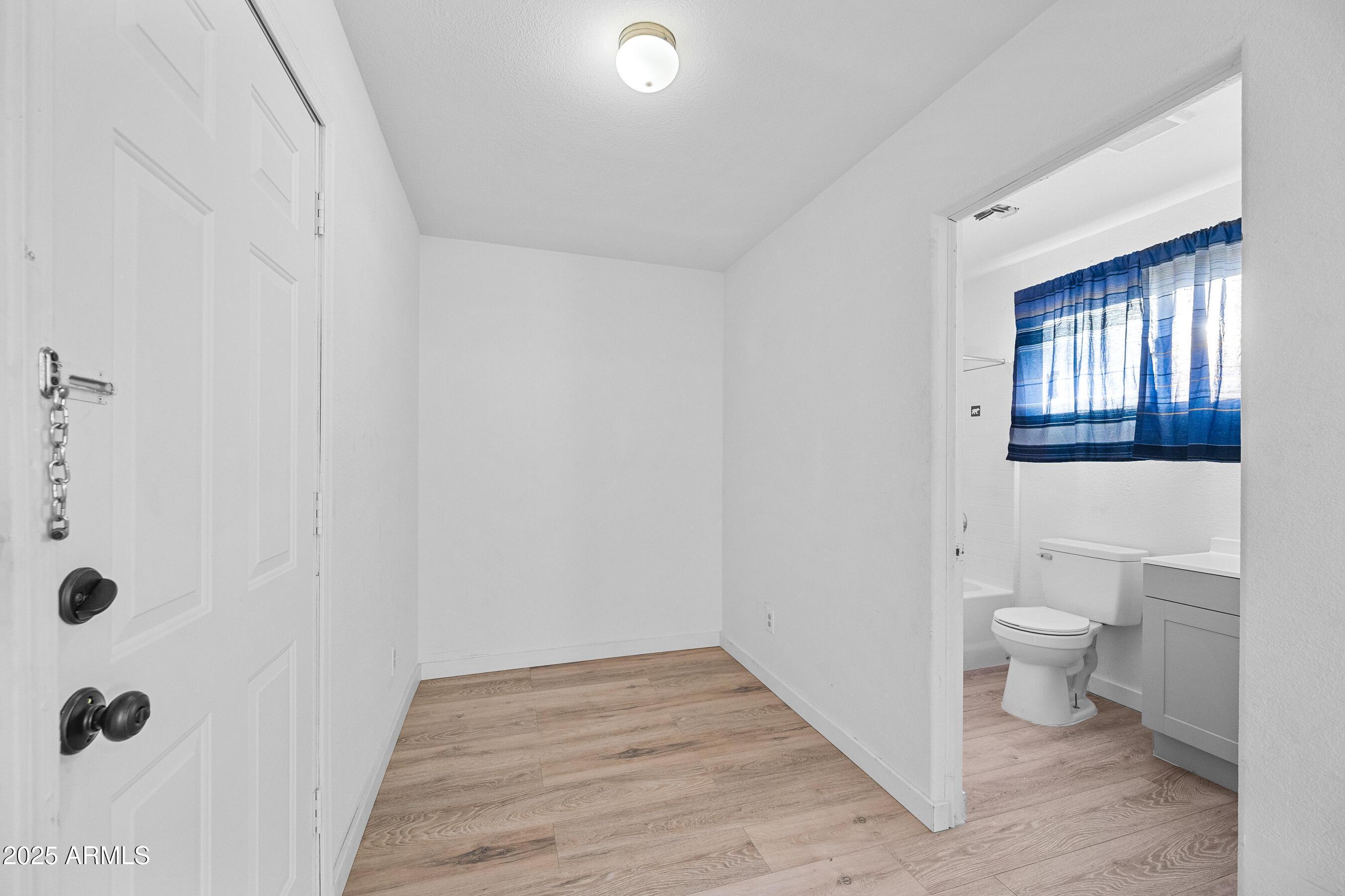 2057 East 10th Street Tempe, AZ 85281 - Photo 22 of 26 a bathroom with a toilet and a shower