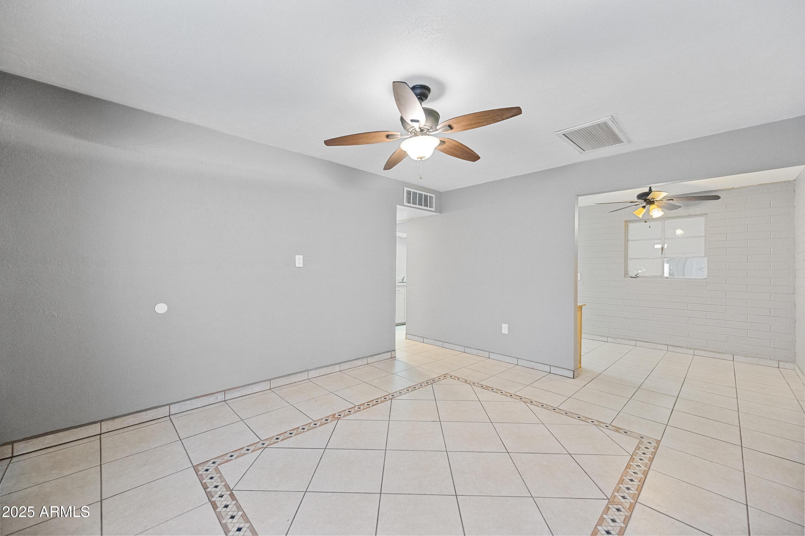 2057 East 10th Street Tempe, AZ 85281 - Photo 4 of 26 a view of an empty room and chandelier fan