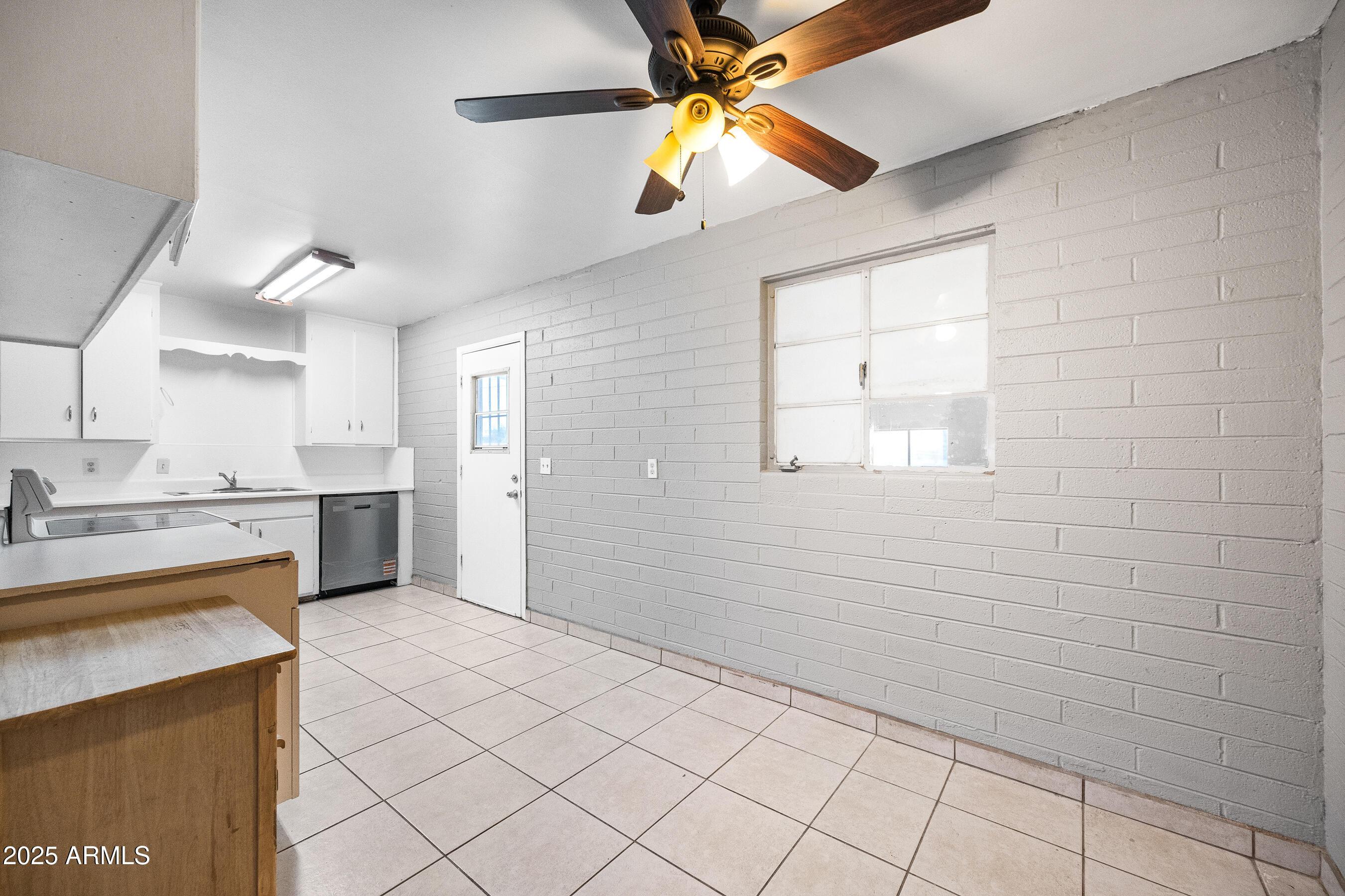 2057 East 10th Street Tempe, AZ 85281 - Photo 5 of 26 a view of a kitchen with a sink and cabinets