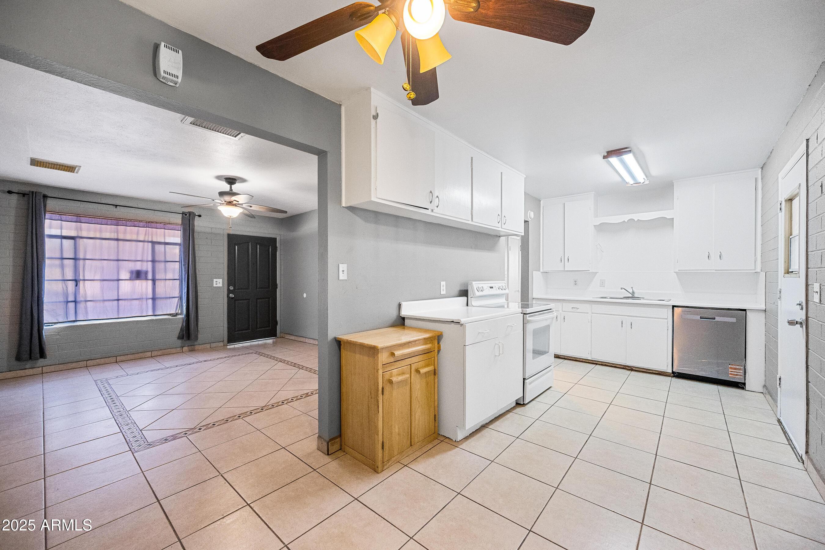 2057 East 10th Street Tempe, AZ 85281 - Photo 6 of 26 a kitchen with a stove a sink and a refrigerator