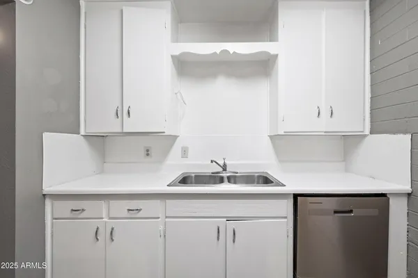 a kitchen with a sink and cabinets