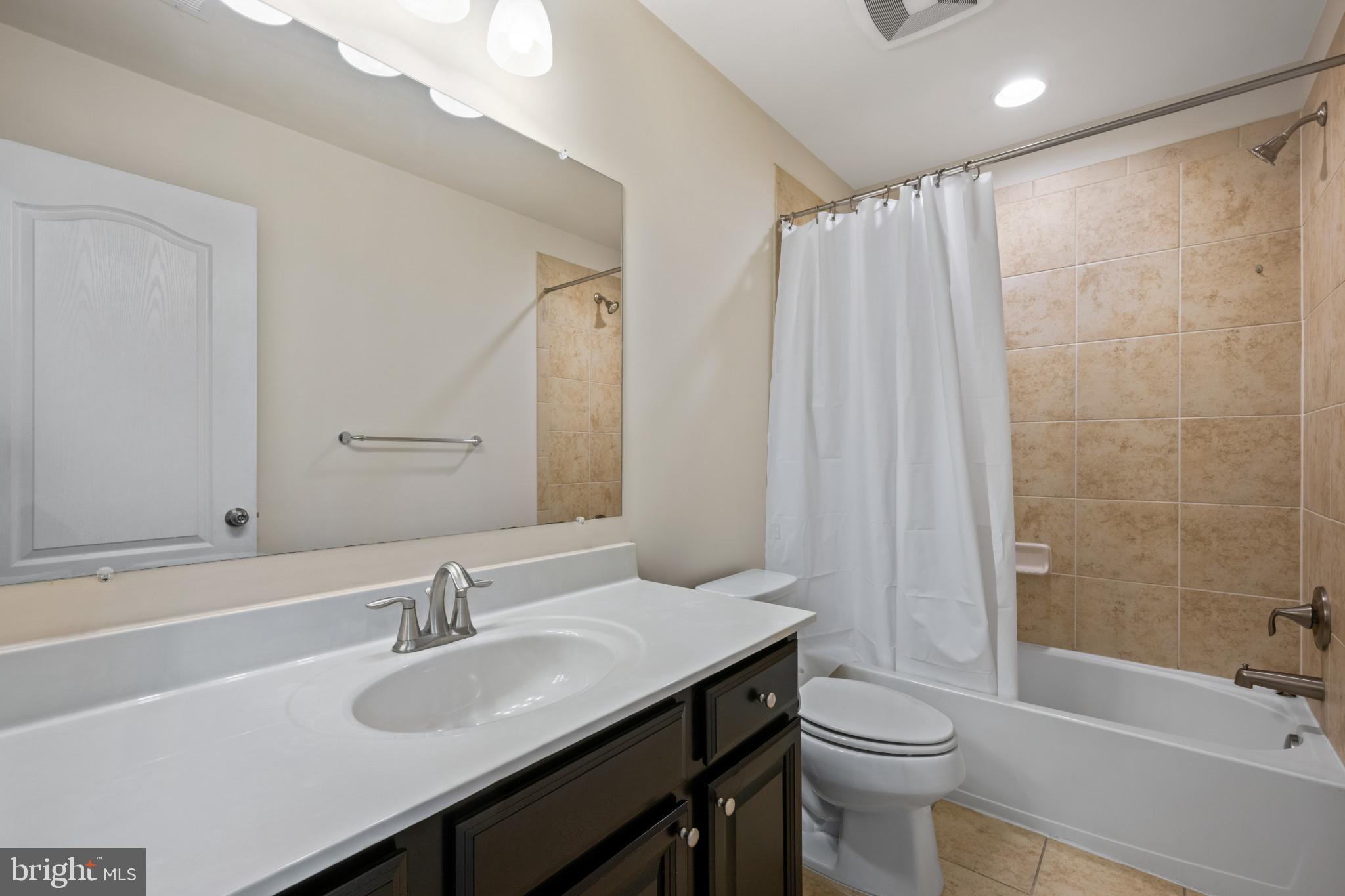 7062 Foxton Way Hanover, MD 21076 - Photo 21 of 41 a bathroom with a sink a toilet and shower