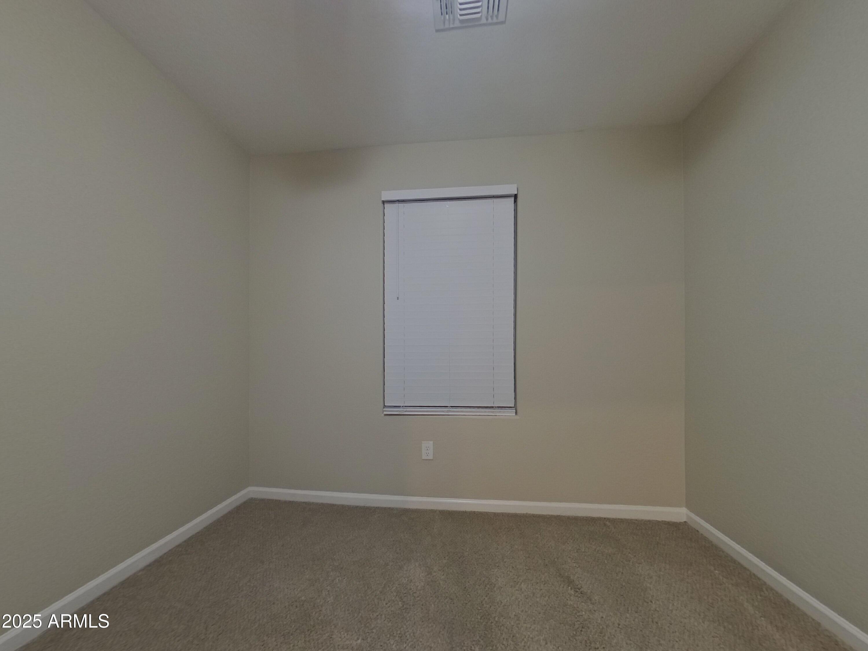 12578 West Steed Ridge Peoria, AZ 85383 - Photo 11 of 17 an empty room with a window