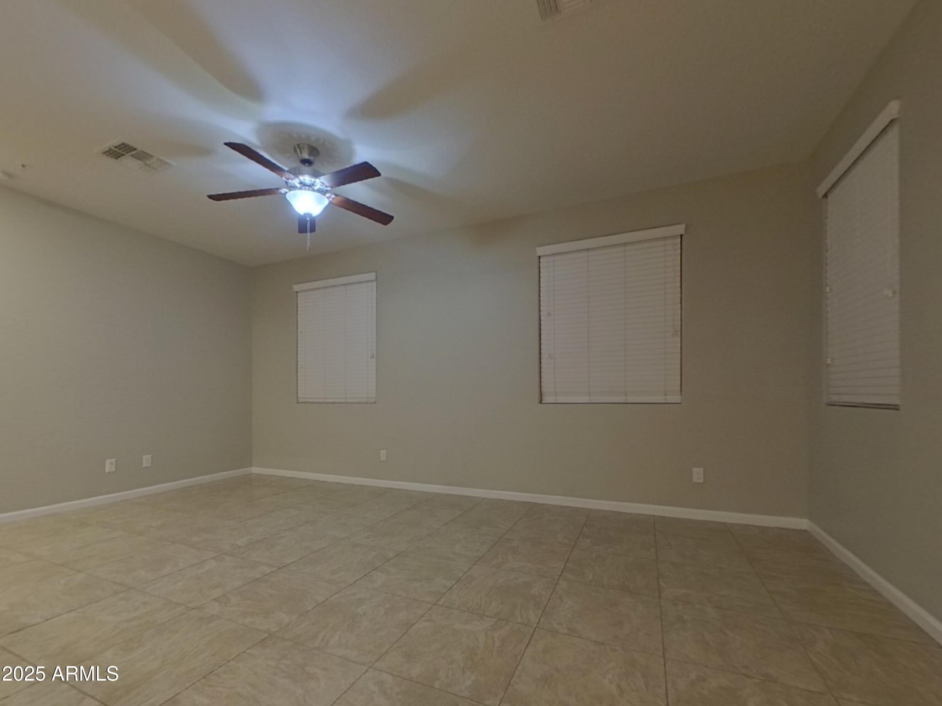 12578 West Steed Ridge Peoria, AZ 85383 - Photo 2 of 17 an empty room with a view of a house