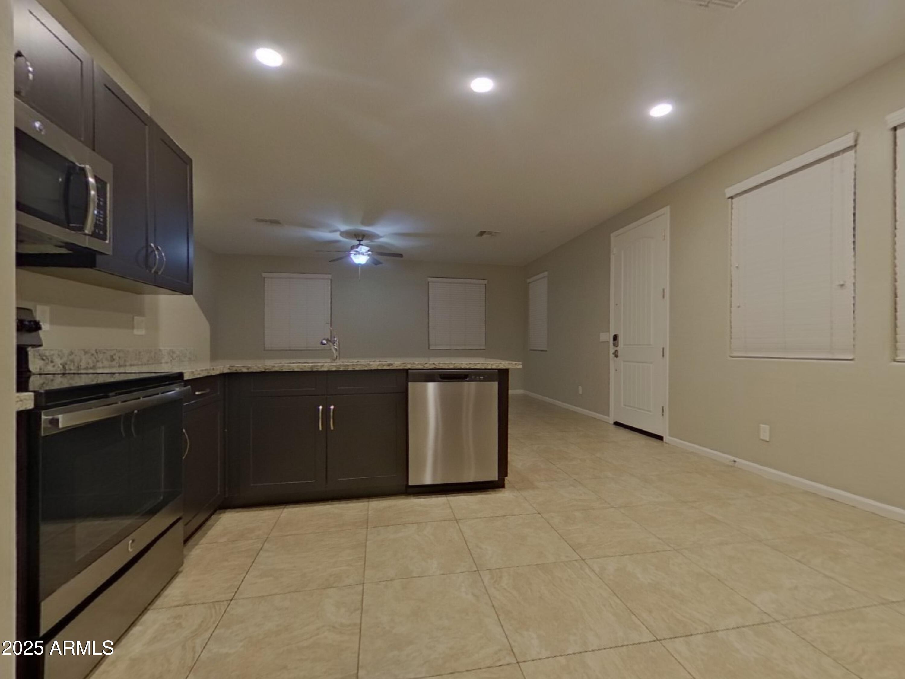 12578 West Steed Ridge Peoria, AZ 85383 - Photo 5 of 17 a kitchen with a sink cabinets and stainless steel appliances