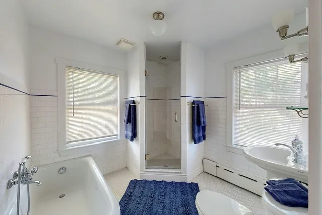 a bathroom with a tub toilet and sink