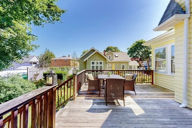 a view of a wooden chairs on the roof deck