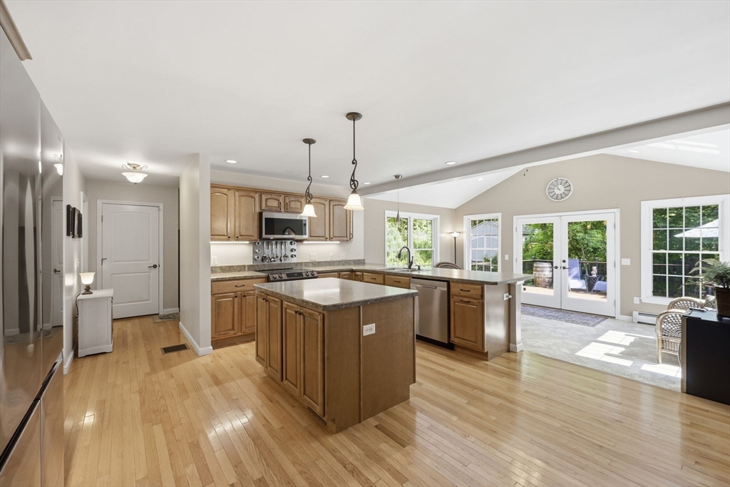 345 Bragg Road Warren, MA 01585 - Photo 13 of 41 a large kitchen with a lot of counter space and a wooden floor