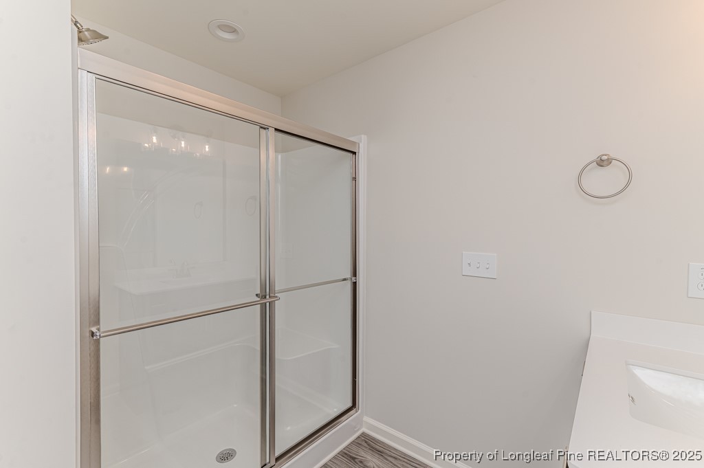 87 Onslow Court Spring Lake, NC 28390 - Photo 19 of 33 a bathroom with a glass shower door