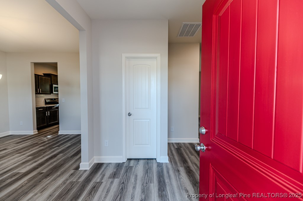 87 Onslow Court Spring Lake, NC 28390 - Photo 4 of 33 a view of a hallway with wooden floor and closet
