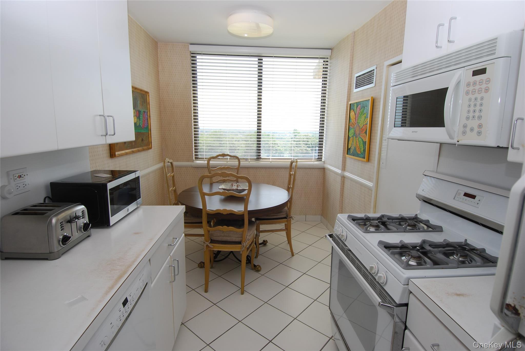 269 Grand Central Parkway, Unit 5V Queens, NY 11005 - Photo 12 of 19 a kitchen with a stove a sink and a microwave