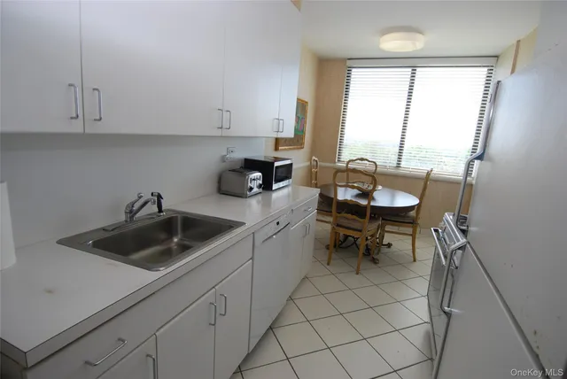 a kitchen with a sink cabinets and a stove top oven