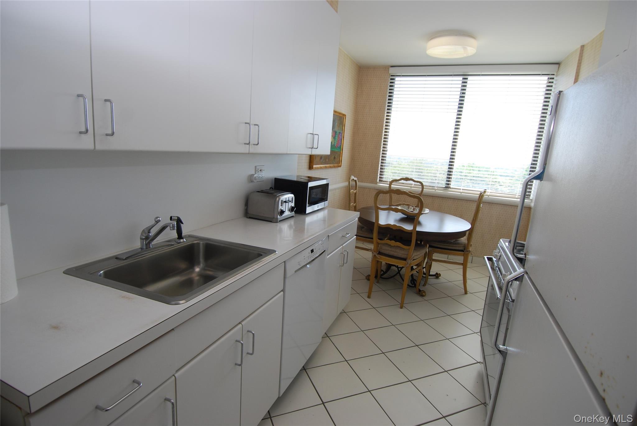 269 Grand Central Parkway, Unit 5V Queens, NY 11005 - Photo 13 of 19 a kitchen with a sink cabinets and a stove top oven