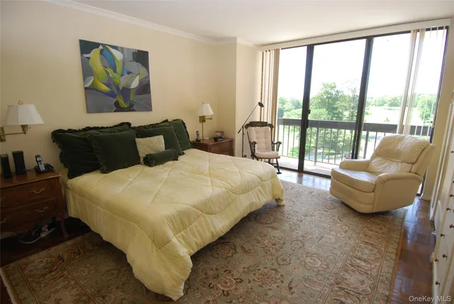 a bedroom with bed and glass window