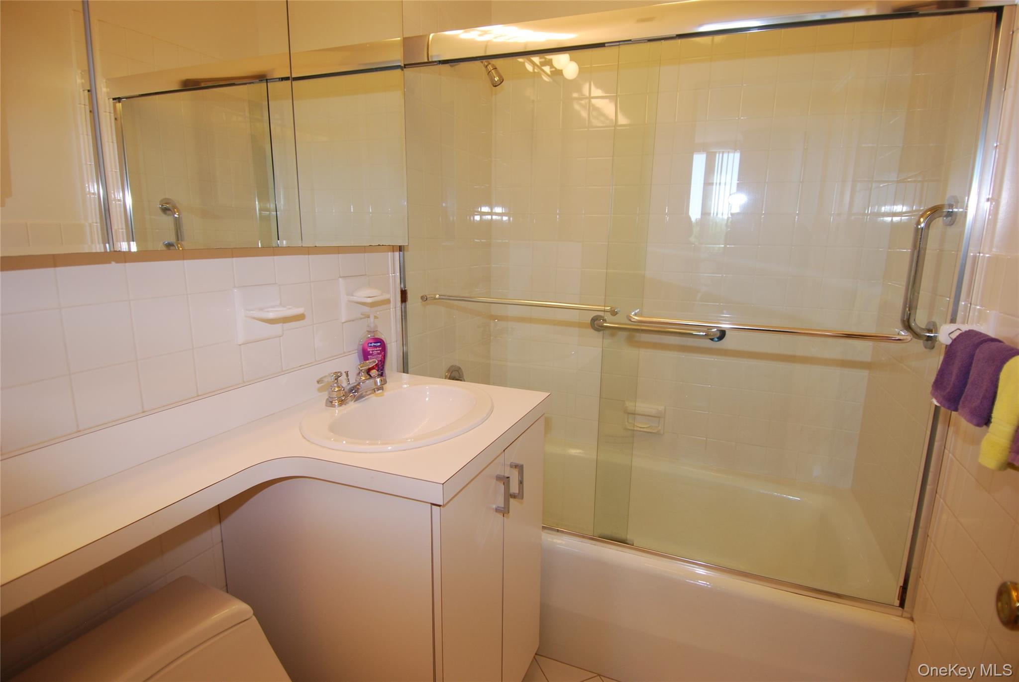 269 Grand Central Parkway, Unit 5V Queens, NY 11005 - Photo 18 of 19 a bathroom with a sink a shower and a mirror