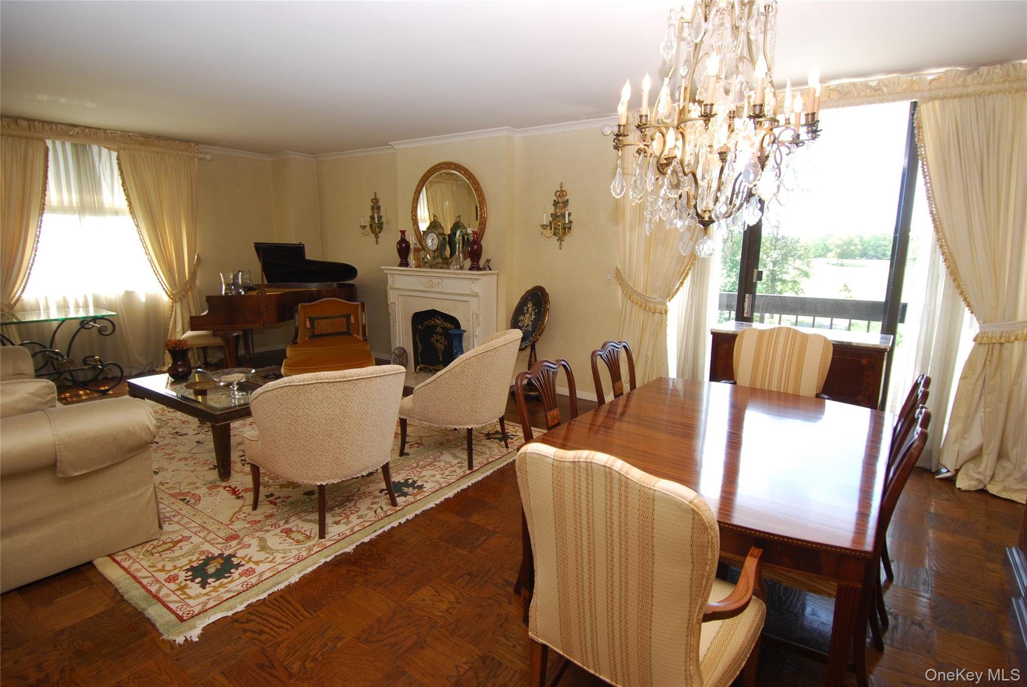 269 Grand Central Parkway, Unit 5V Queens, NY 11005 - Photo 3 of 19 a living room with furniture a chandelier and a table