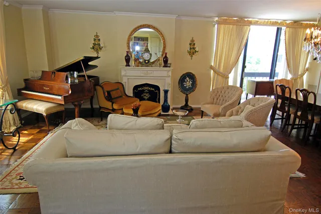a living room with fireplace furniture and a large window