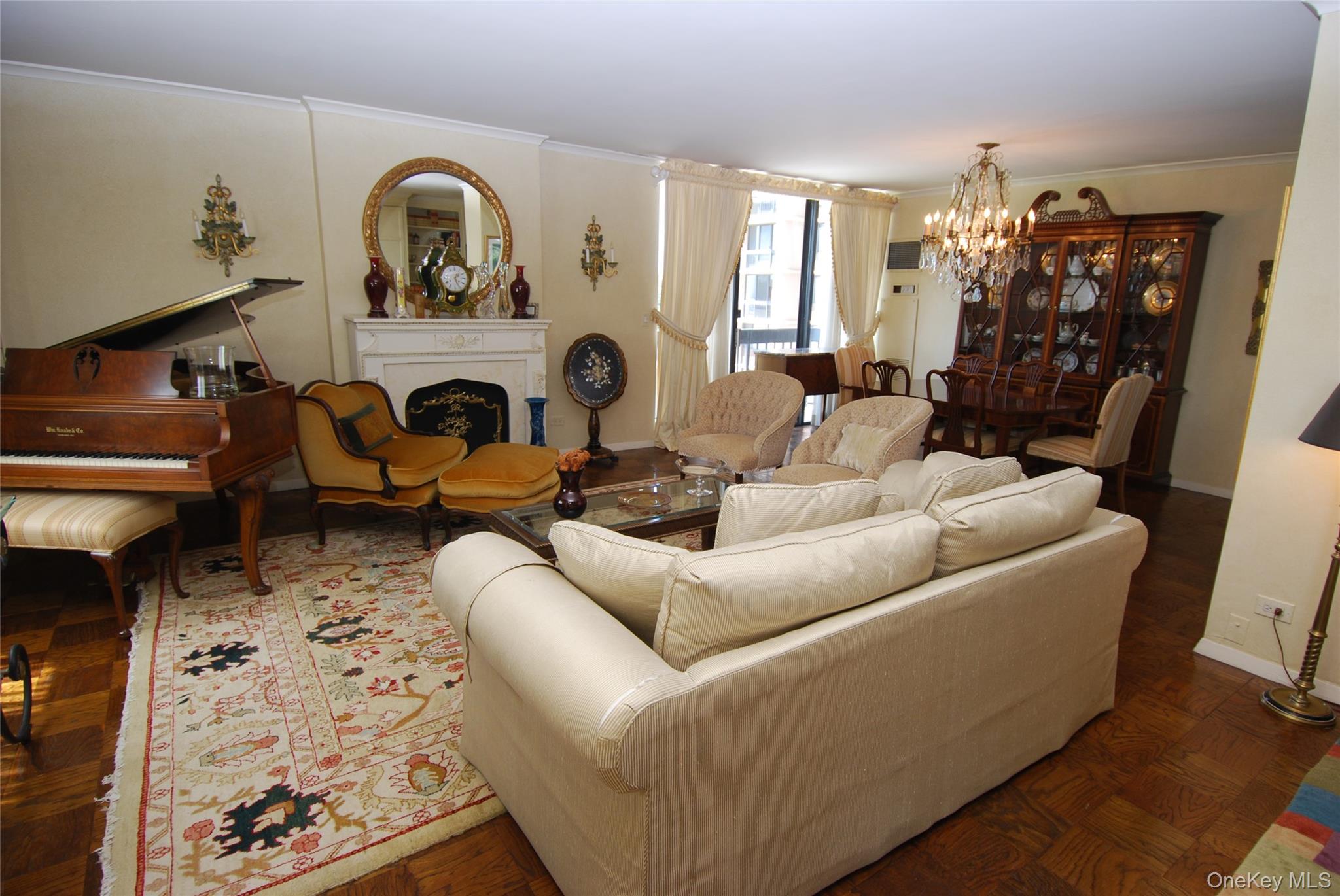 269 Grand Central Parkway, Unit 5V Queens, NY 11005 - Photo 8 of 19 a living room with furniture a fireplace and a chandelier