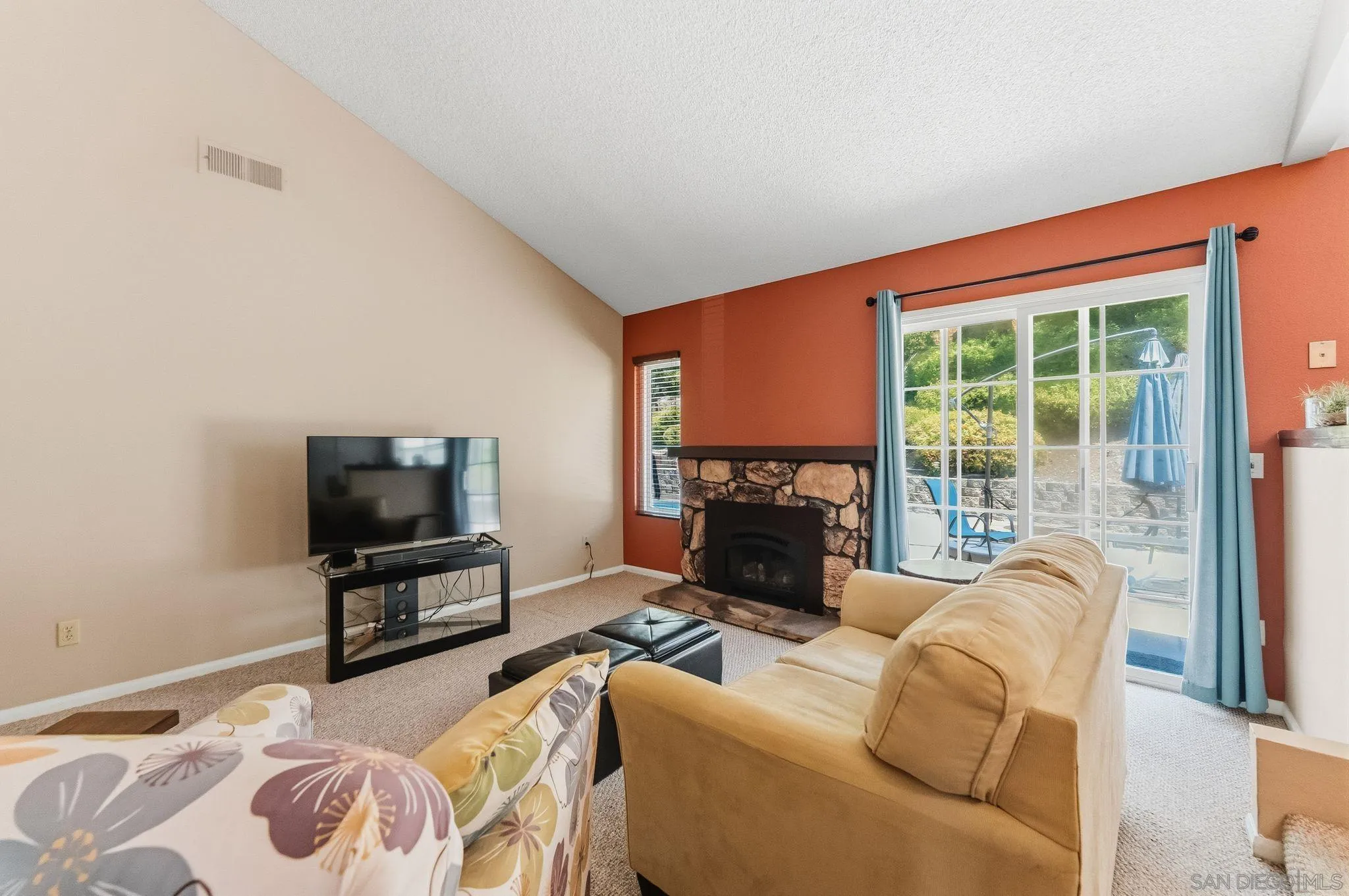 10565 Strathmore Drive Santee, CA 92071 - Photo 14 of 59 a living room with furniture a flat screen tv and a floor to ceiling window