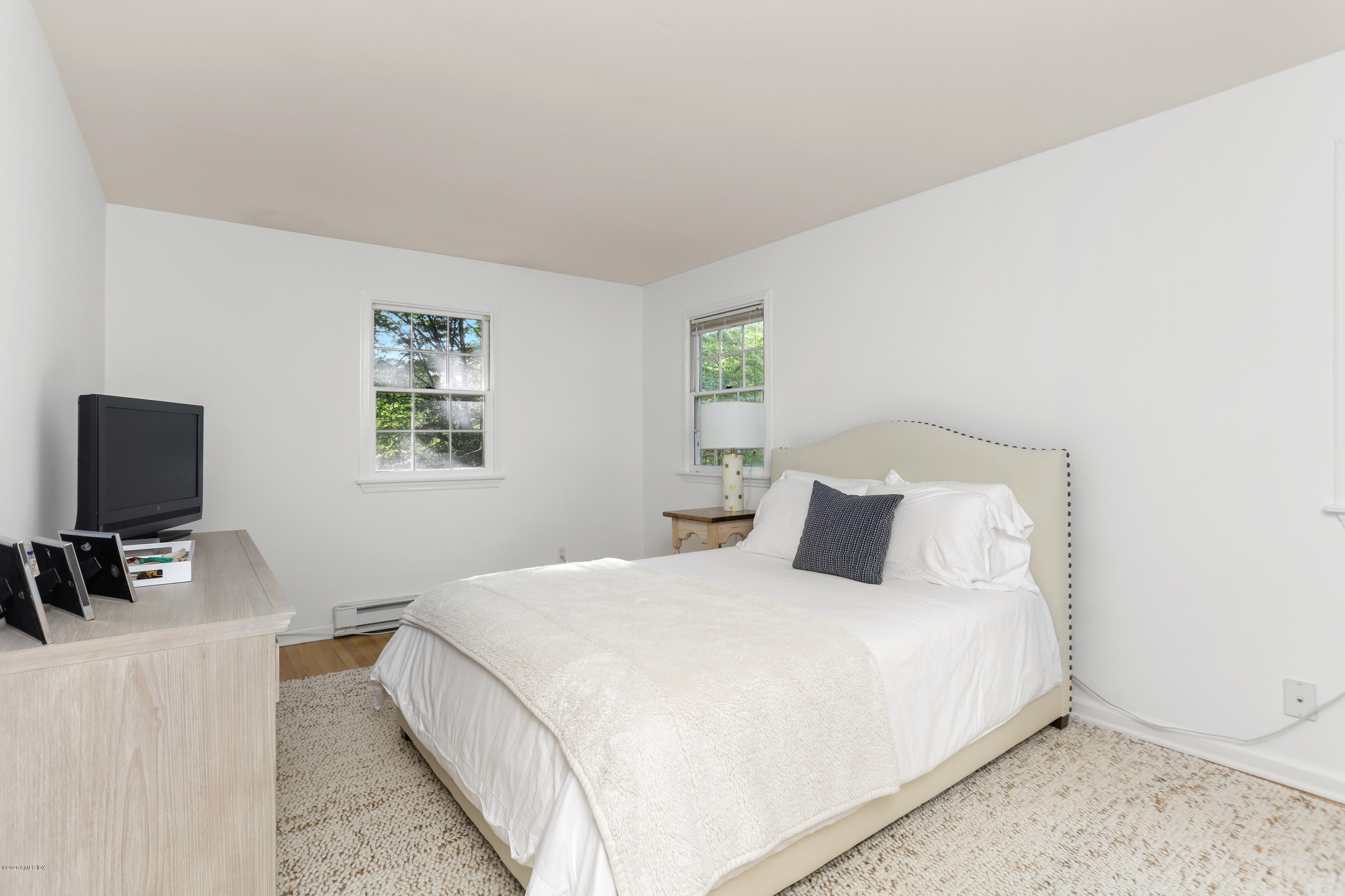 36 Butler Street Cos Cob, CT 06807 - Photo 7 of 12 a bedroom with a bed and a flat screen tv