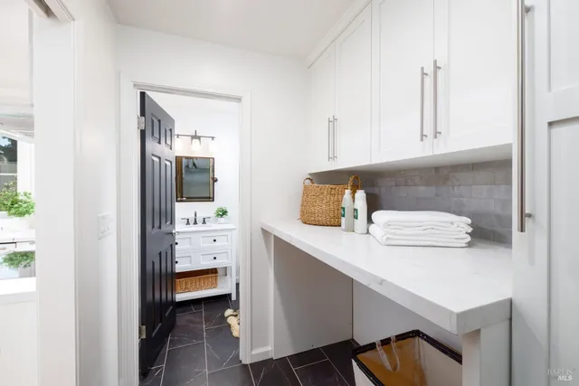 an aerial view of a house with a yard and greenery