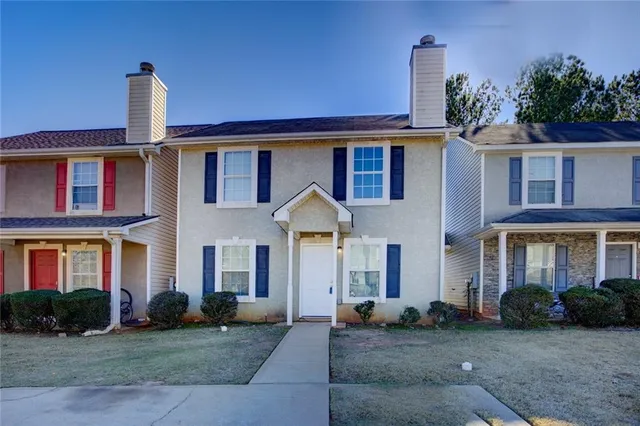 a front view of a house with a yard