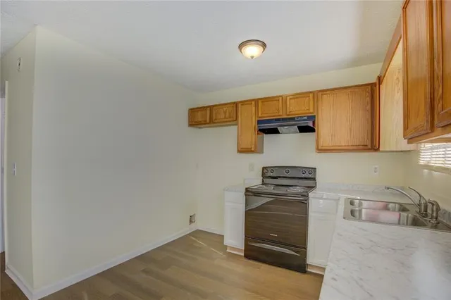 a kitchen with granite countertop cabinets and appliances