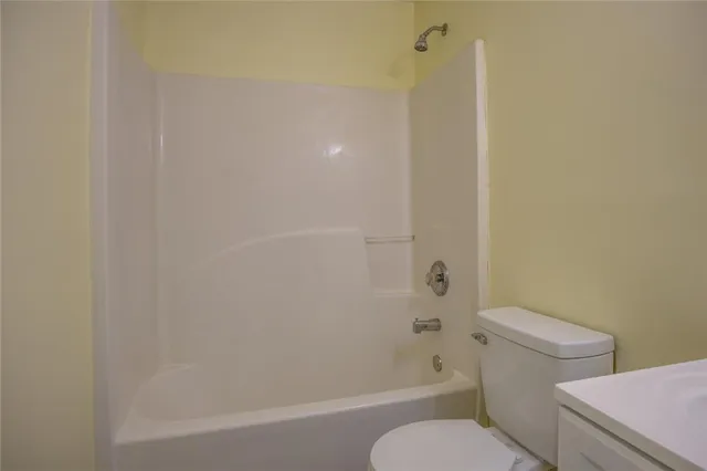 a bathroom with a toilet and a bathtub