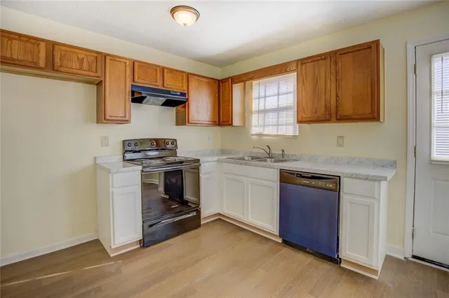 a kitchen with a stove a sink and a microwave