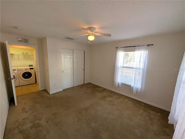 an empty room with windows and closet