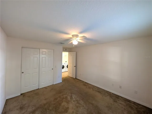 a view of a livingroom with a chandelier fan