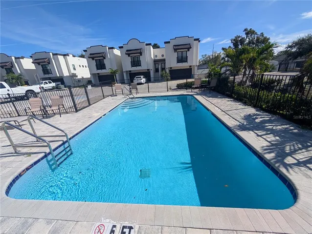 a view of swimming pool with chairs