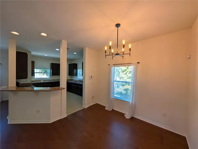 a view of a living room and kitchen with wooden floor