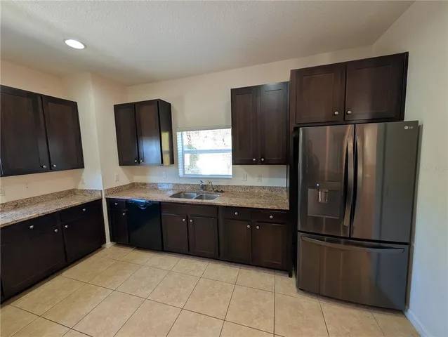 a kitchen with a refrigerator and a sink