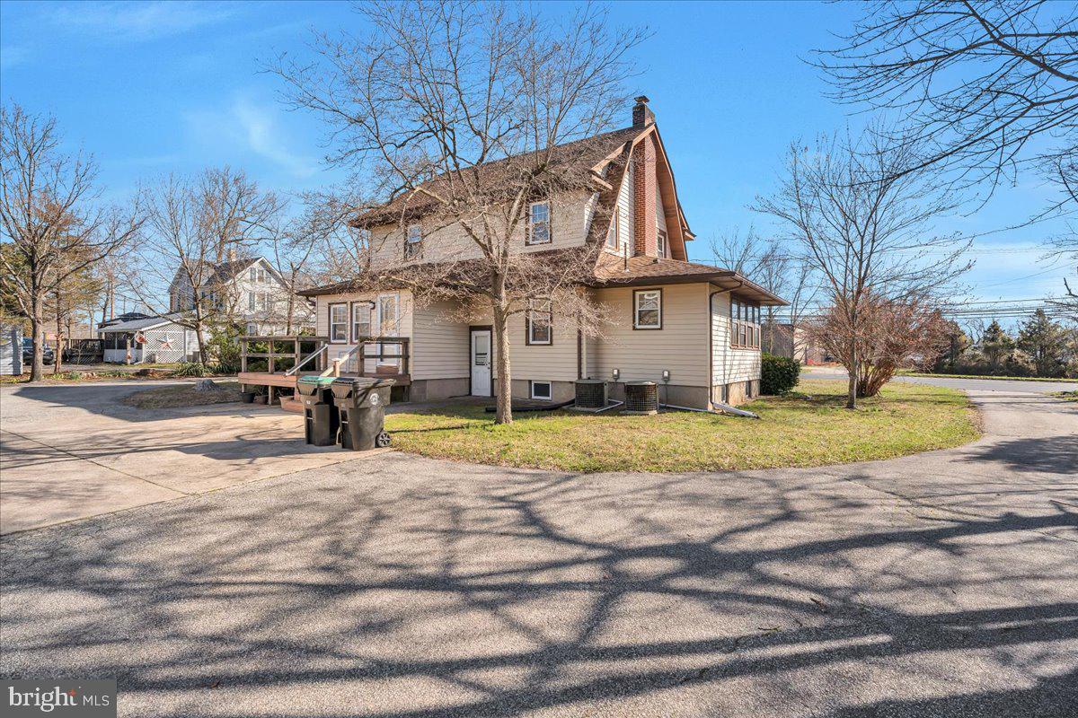 83 South Rte 73 Sicklerville, NJ 08081 - Photo 23 of 24 a view of a white house with a big yard and large trees