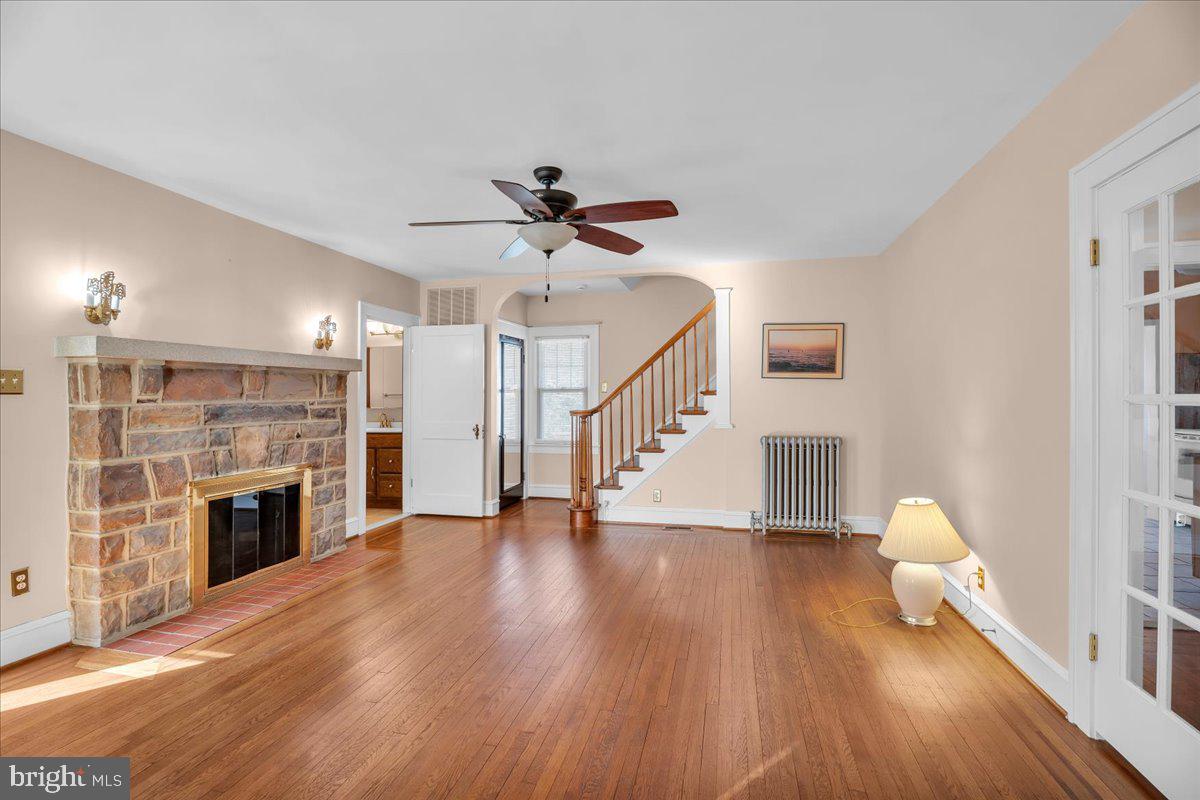 83 South Rte 73 Sicklerville, NJ 08081 - Photo 3 of 24 a view of an empty room with wooden floor a fireplace and a window