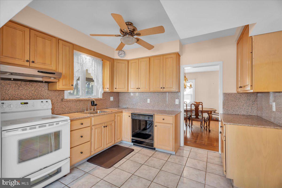 83 South Rte 73 Sicklerville, NJ 08081 - Photo 7 of 24 a kitchen with granite countertop a stove a sink and a refrigerator