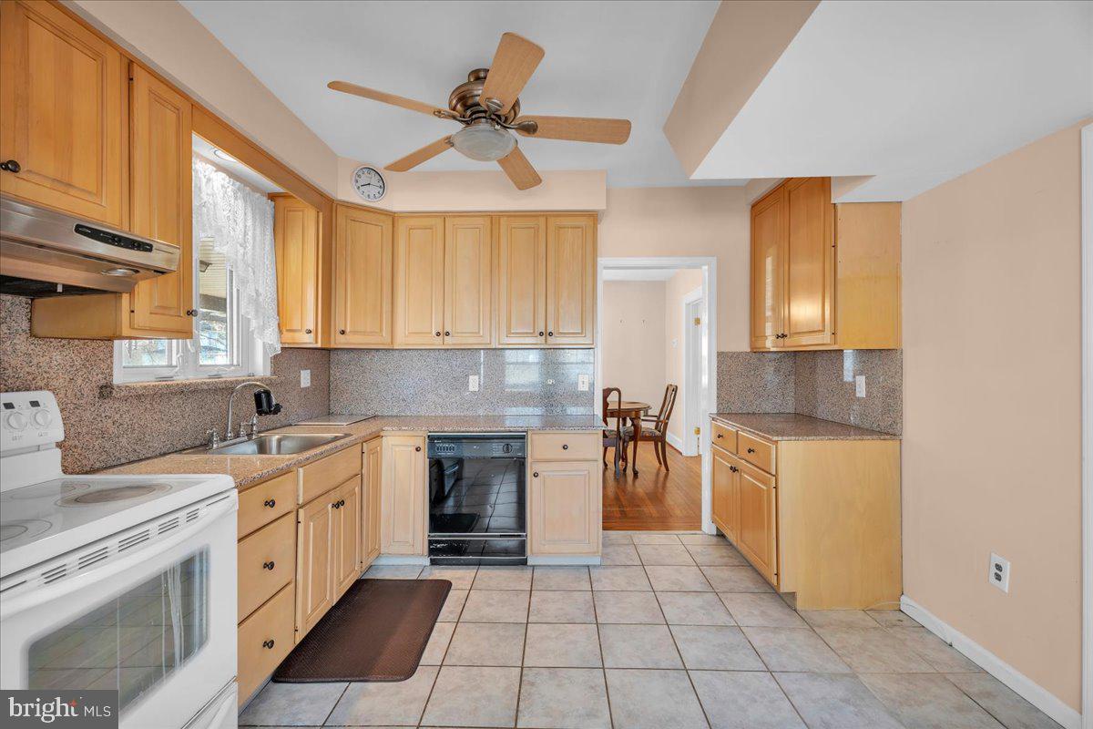 83 South Rte 73 Sicklerville, NJ 08081 - Photo 9 of 24 a kitchen with a stove sink and a refrigerator