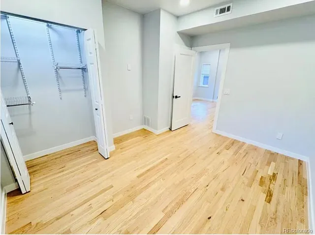 a view of a room with wooden floor and shoes