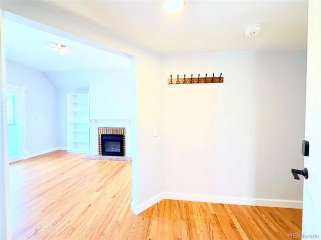 a view of a bedroom with a flat screen tv and kitchen area